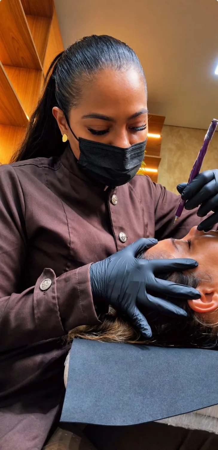 Esinha Costa realizando um procedimento de sobrancelha